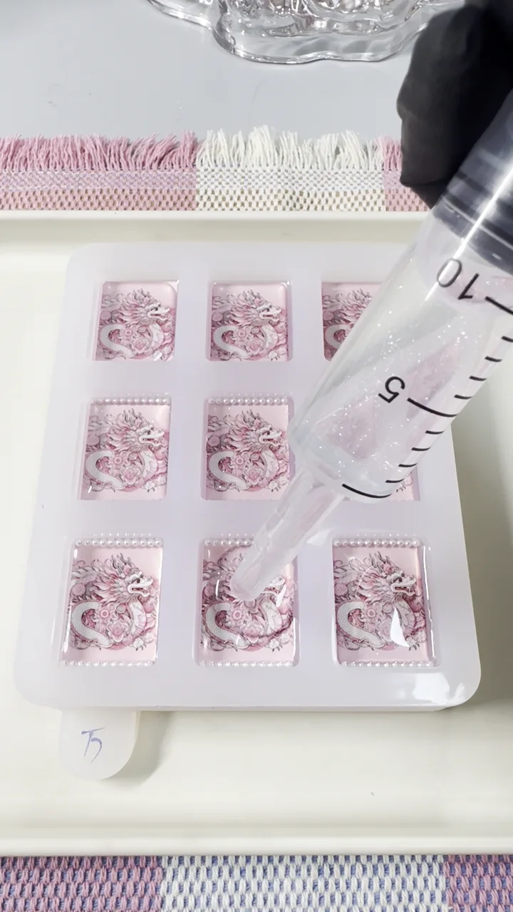 Clear resin being applied to handcrafted pink dragon American Mahjong tile backs