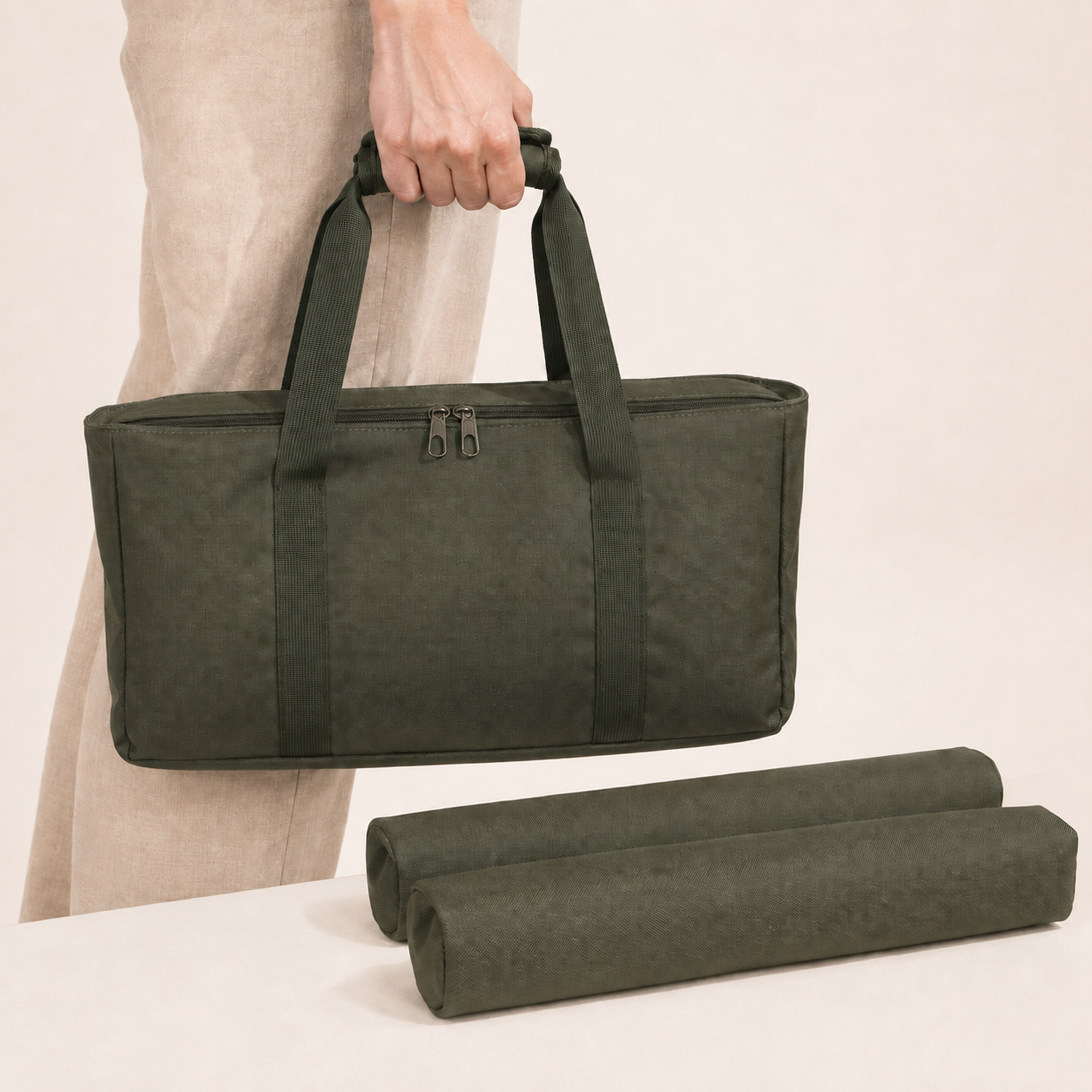 Light Green Mahla tote carried by its matching olive green padded handle wrap